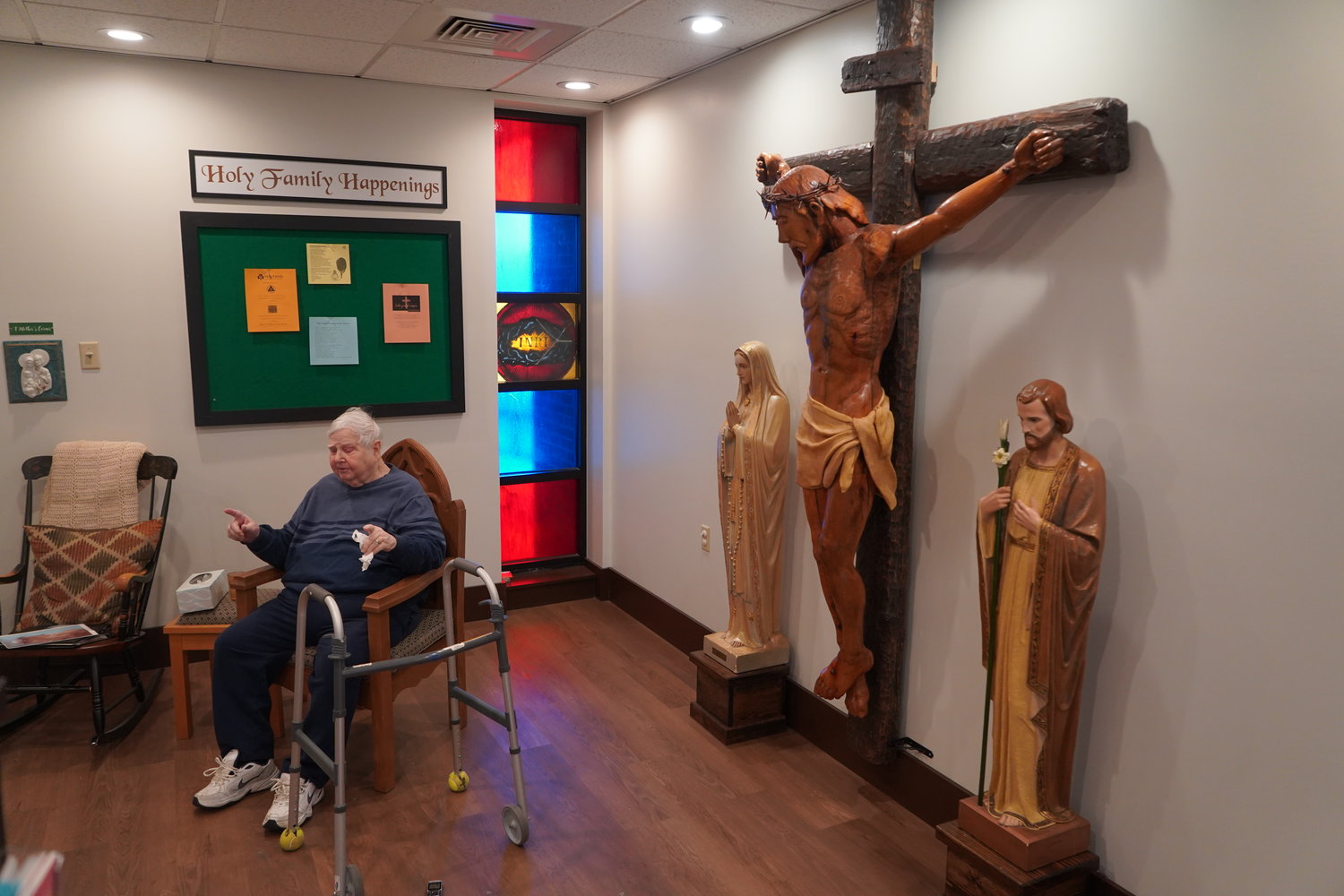 Artist Delbert Hayes tells students of Holy Family School in Hannibal about the crucifix he created about 20 years ago for Holy Family Church. They met with him March 10 in what is not the gathering area for the church.